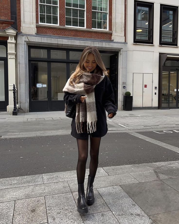 a woman standing on a sidewalk